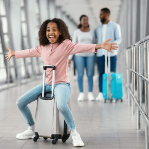 Happy black family traveling with kid, walking in airport